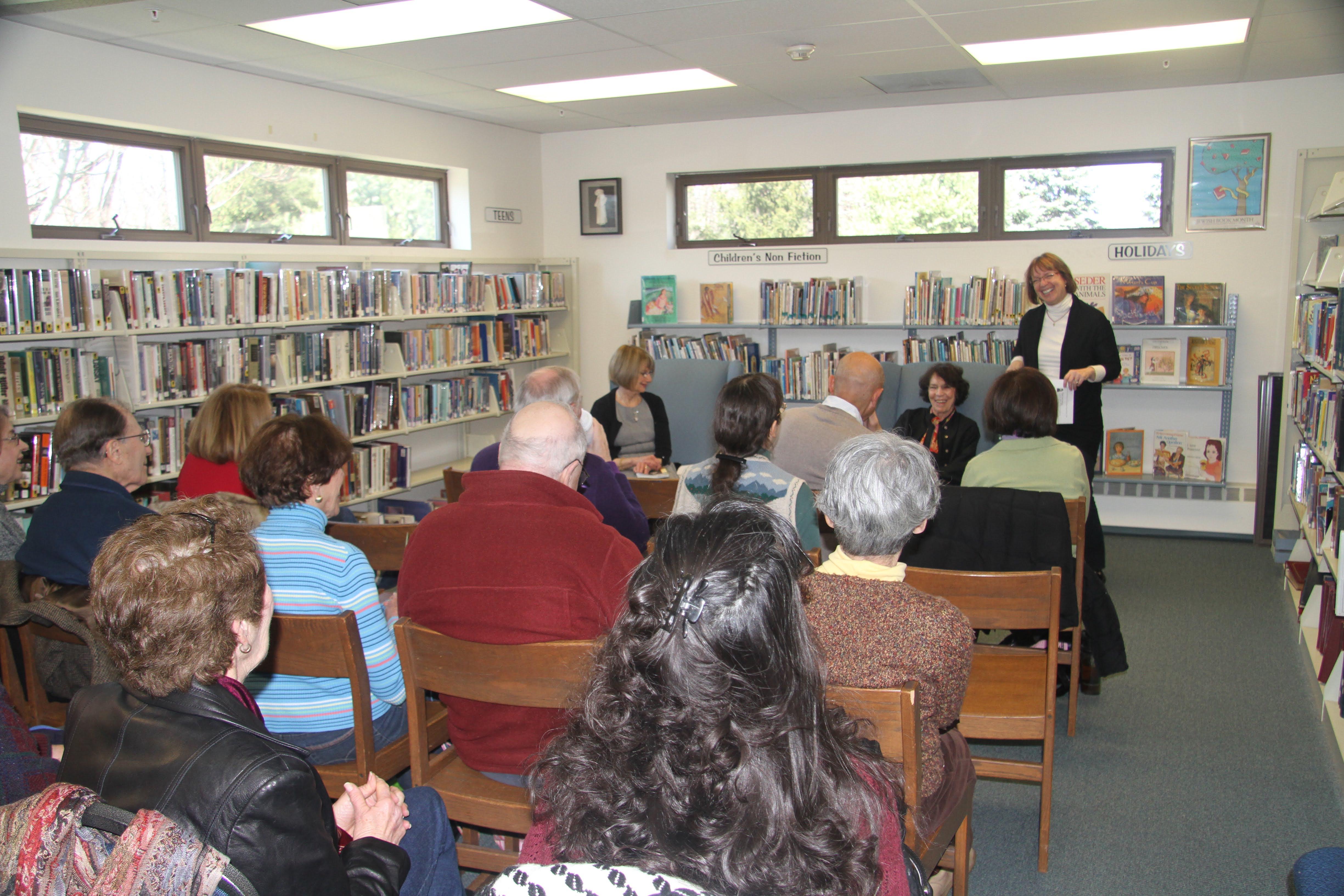 As she reads, autographs her …
