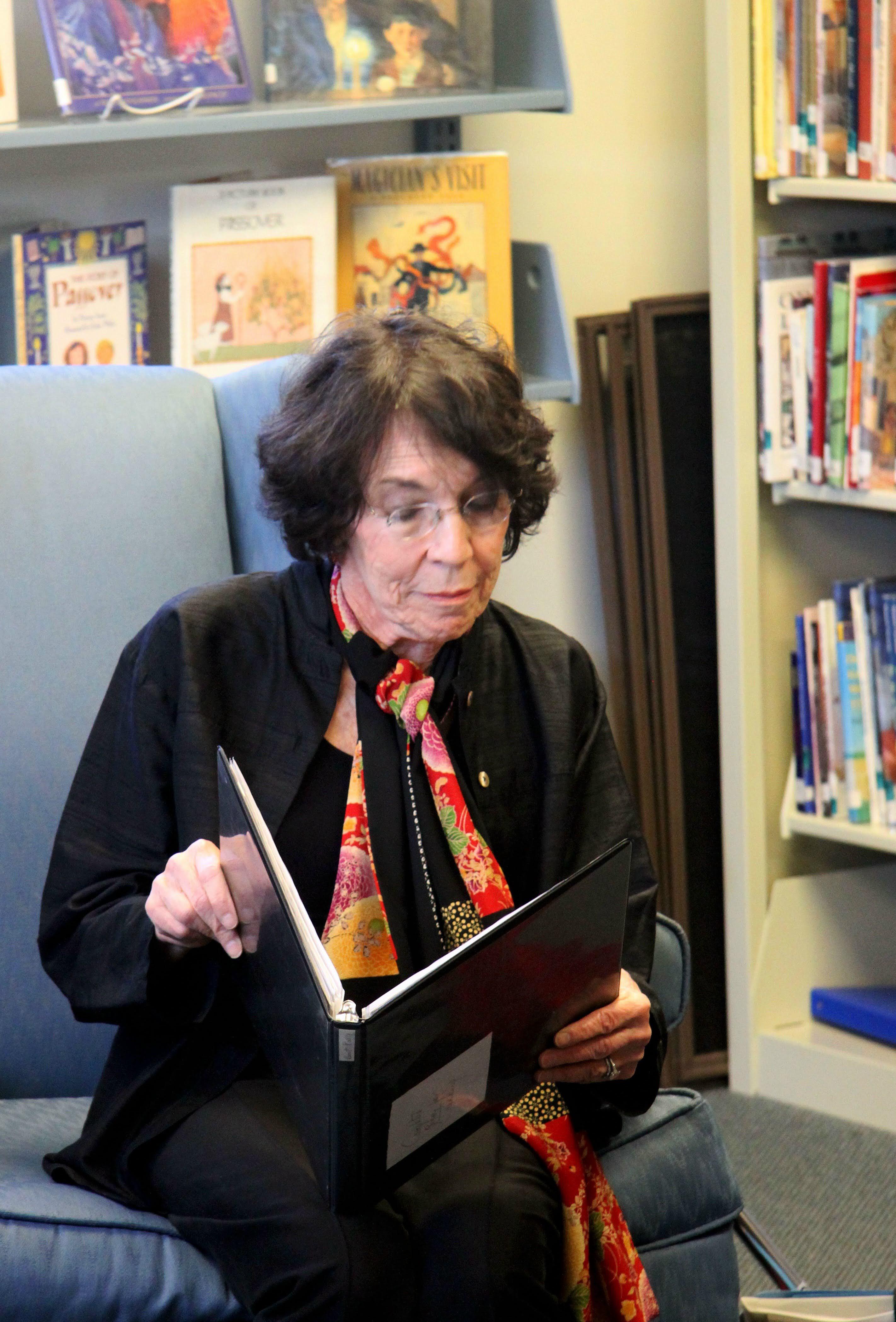 As she reads, autographs her …
