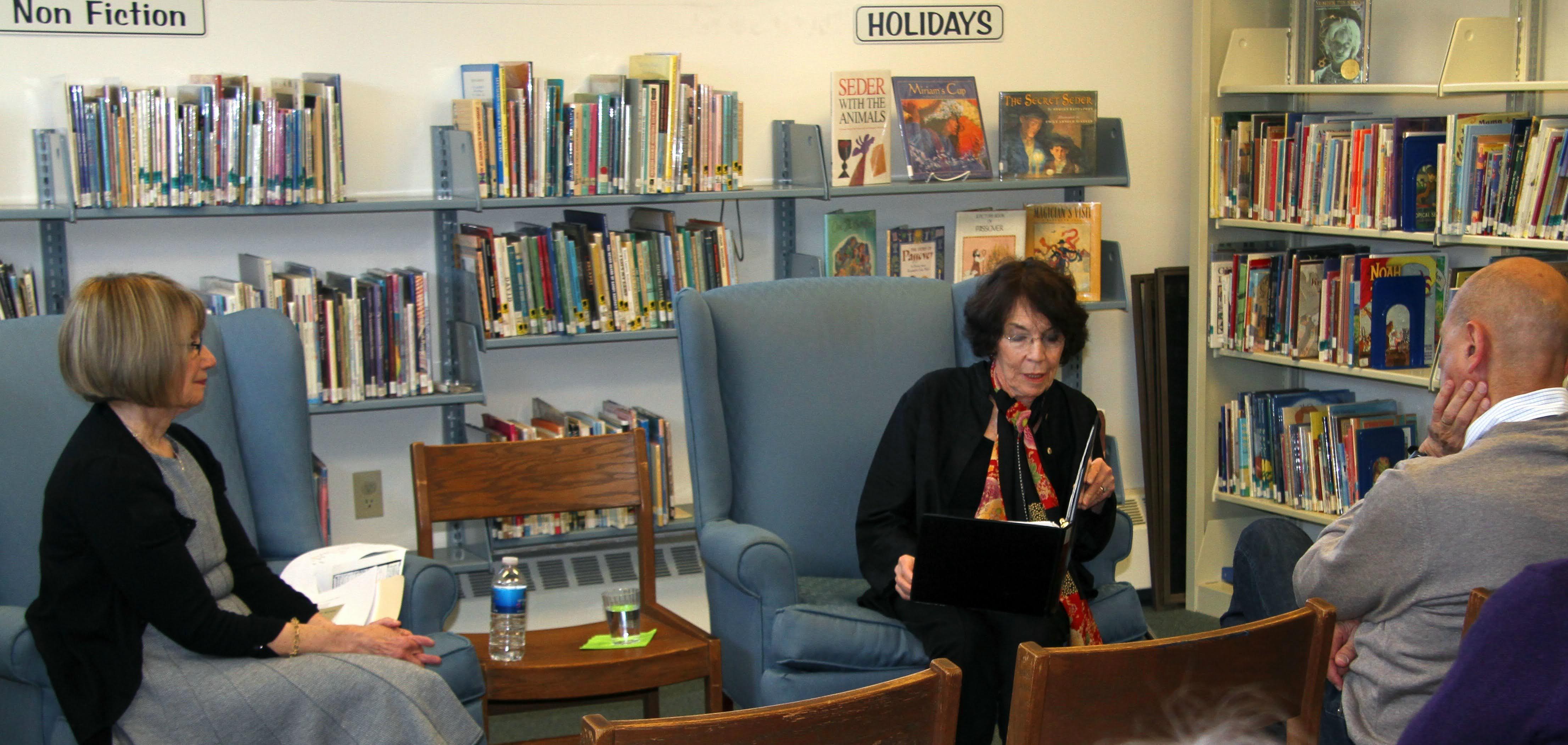 As she reads, autographs her …