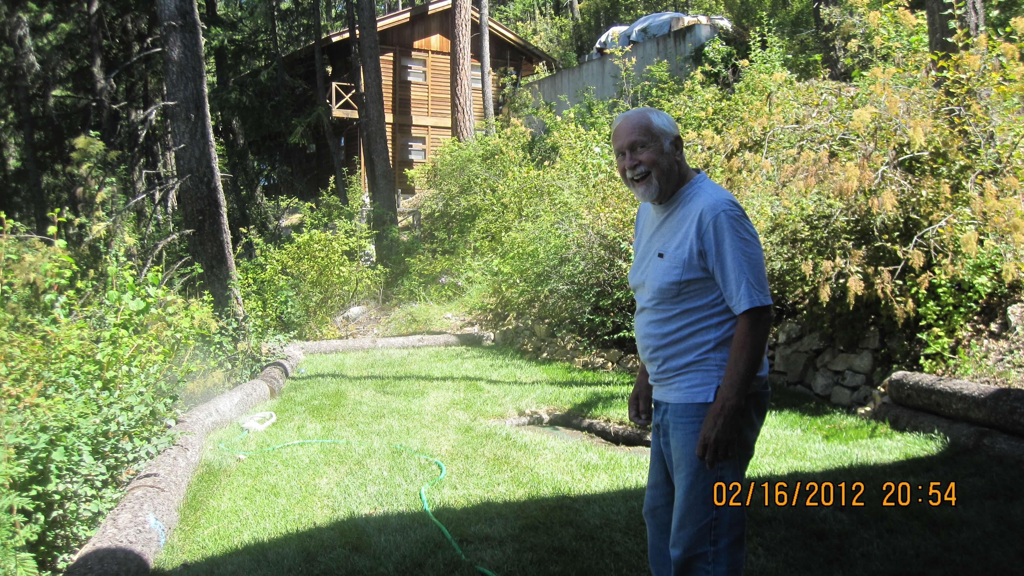 Tending to his lawn.  (the da…