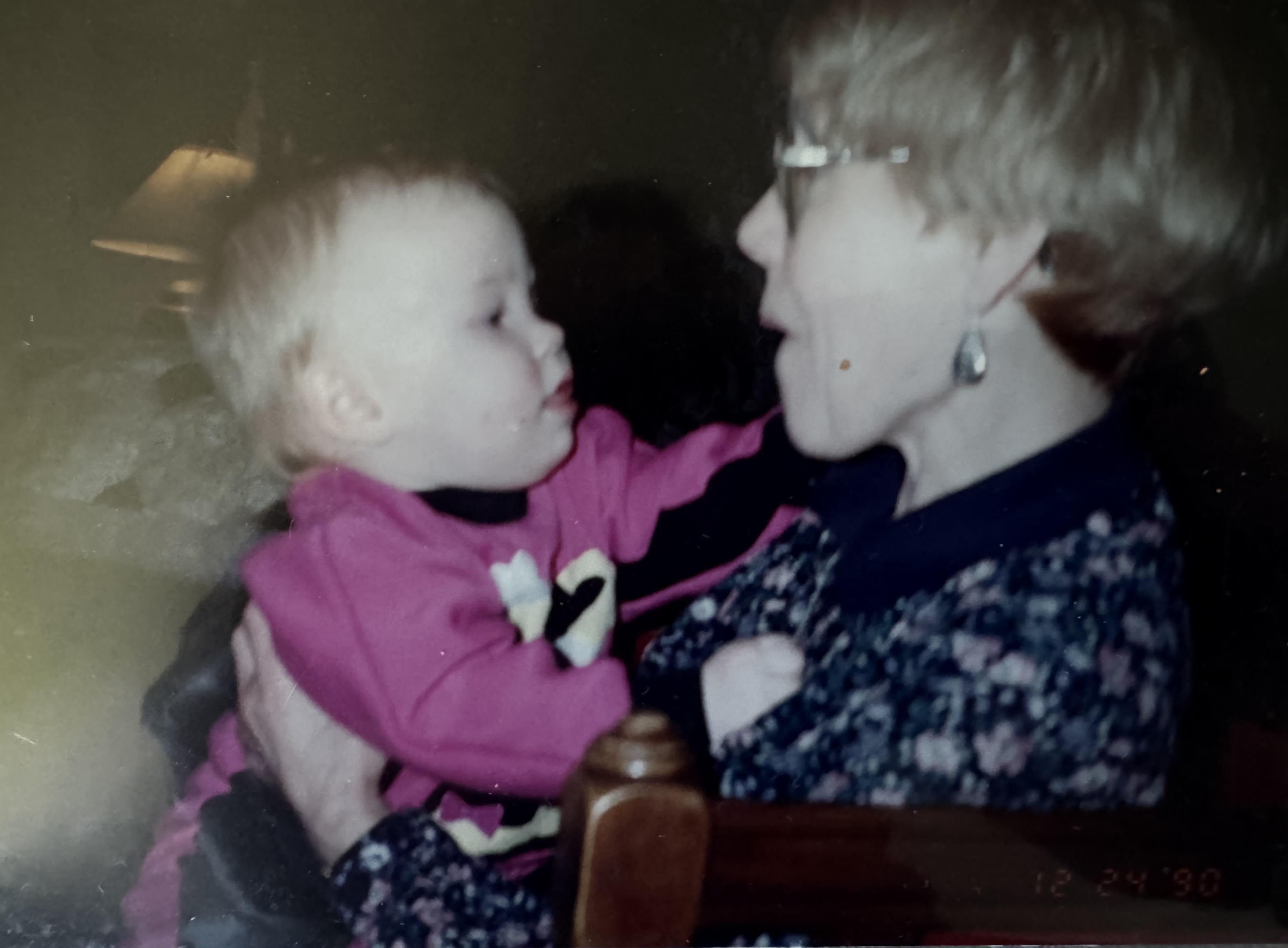 Amy holding granddaughter Lau…