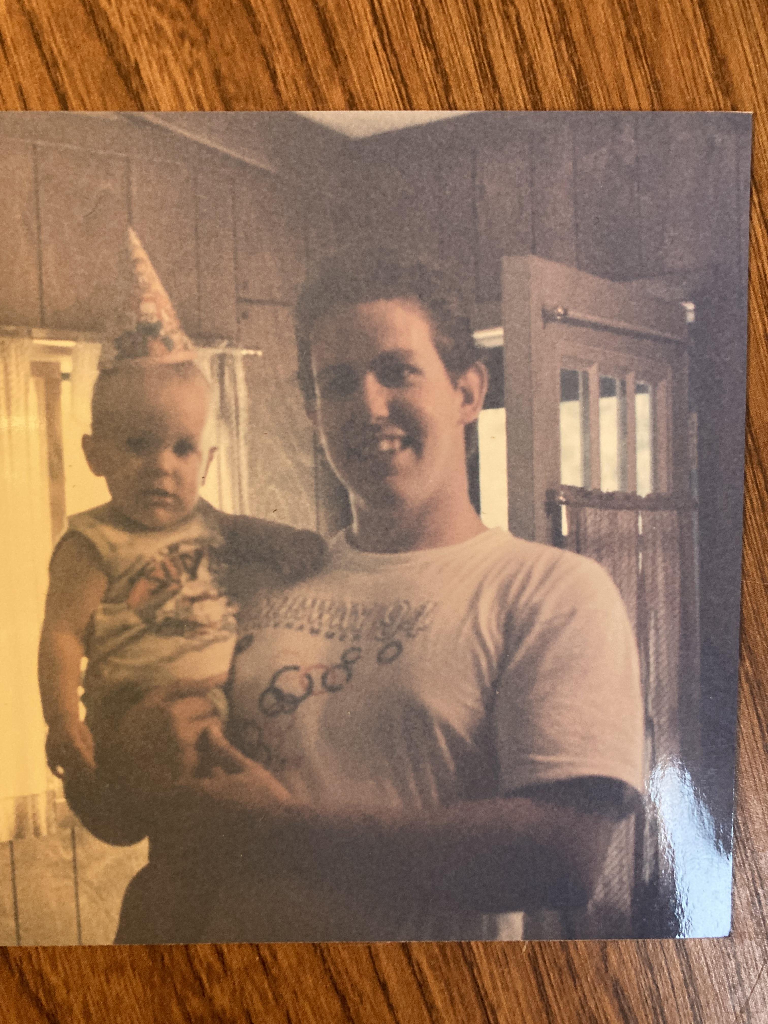 Toby holding Taylor on his ar…