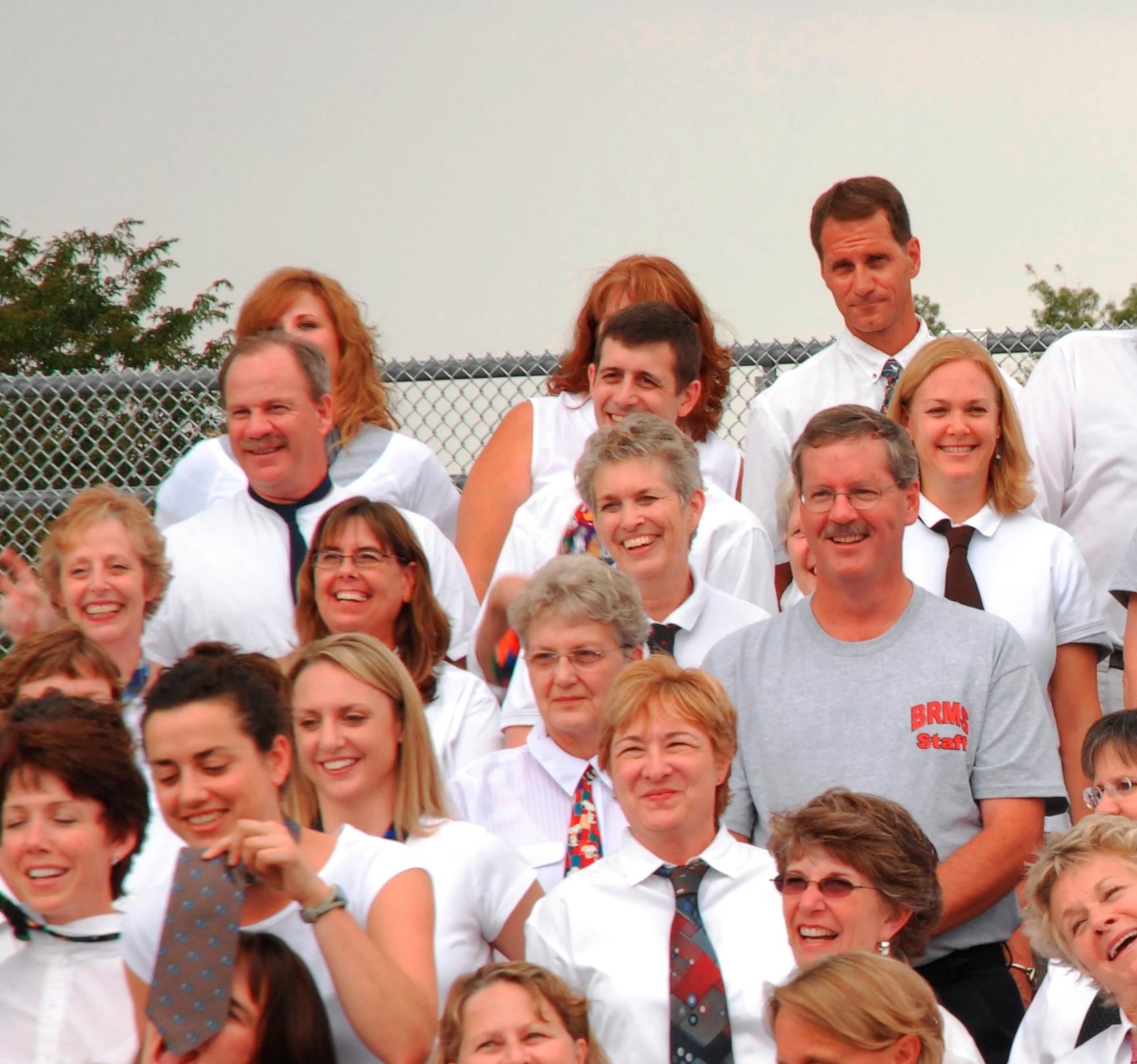 Greg in the midst of staff