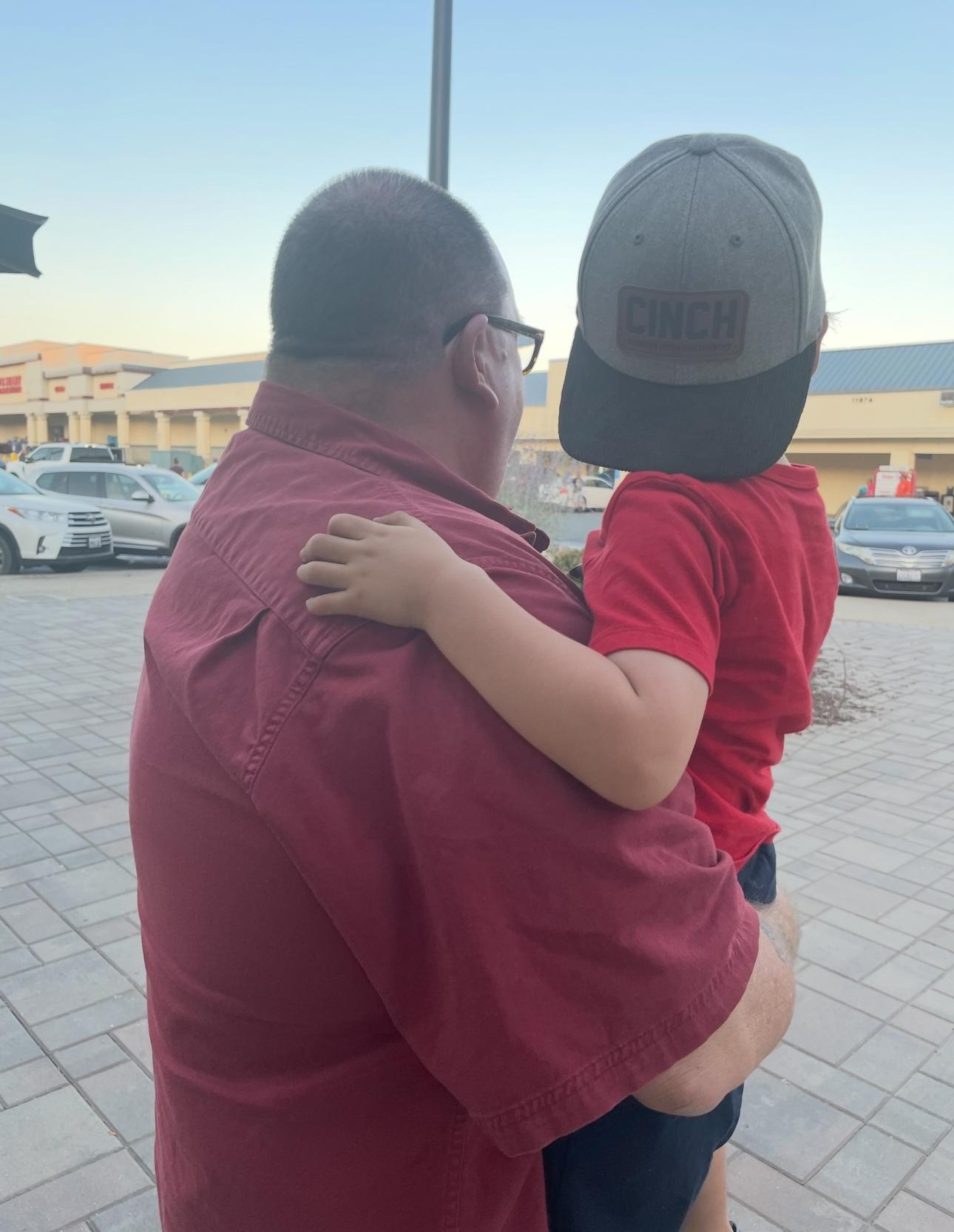 Holding his grandson, Caden (…