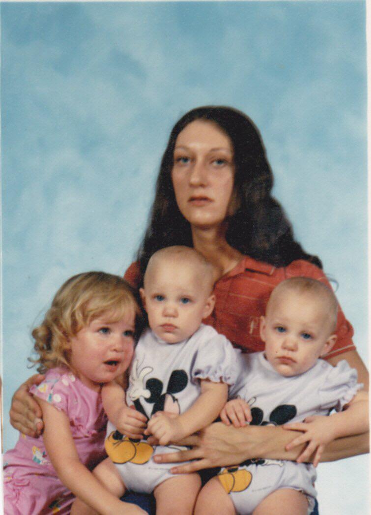 Our beautiful Moma holding us…