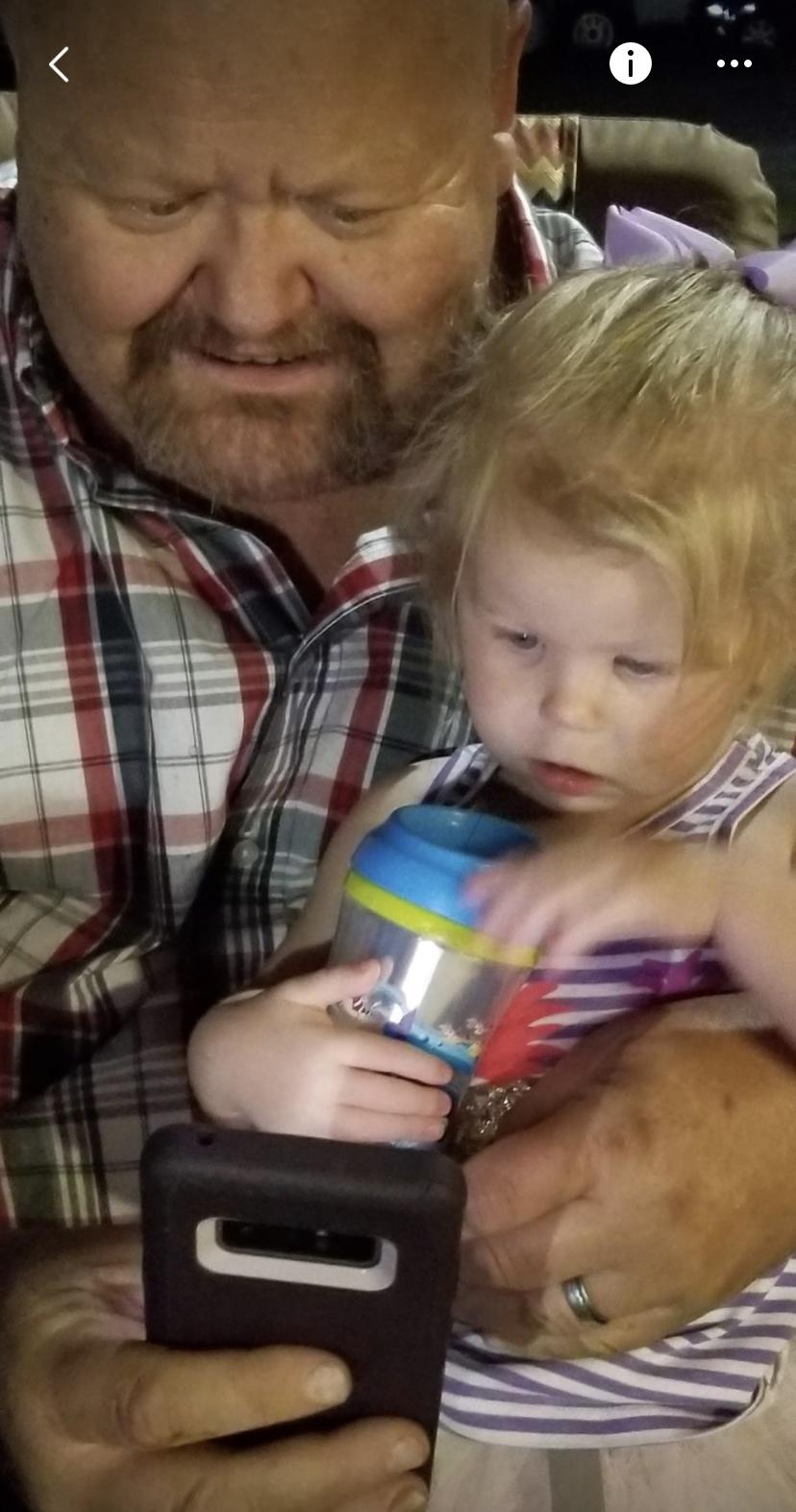 Dad loving on his grand baby.