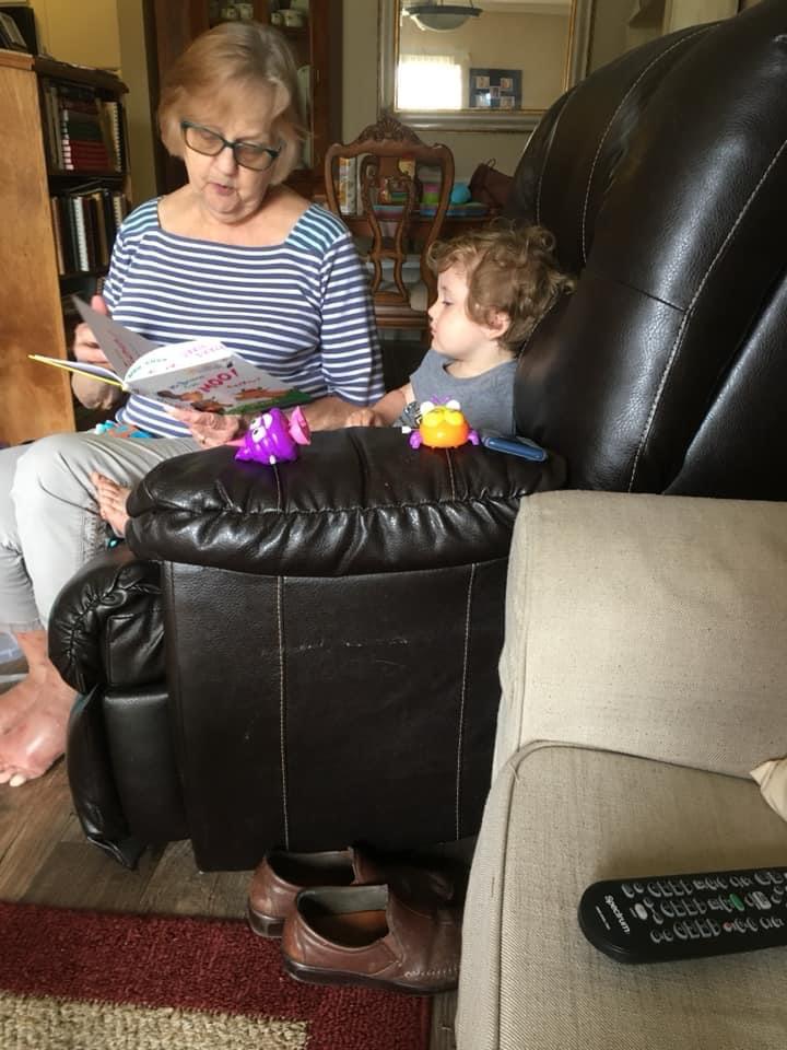 Nana reading to her grandson,…