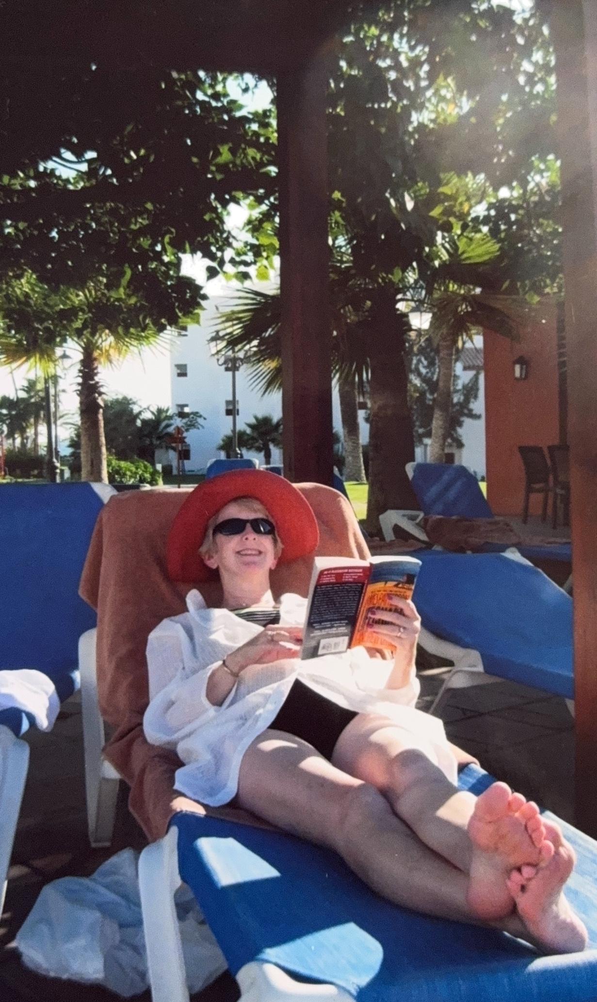 Debbie lounging outside their…
