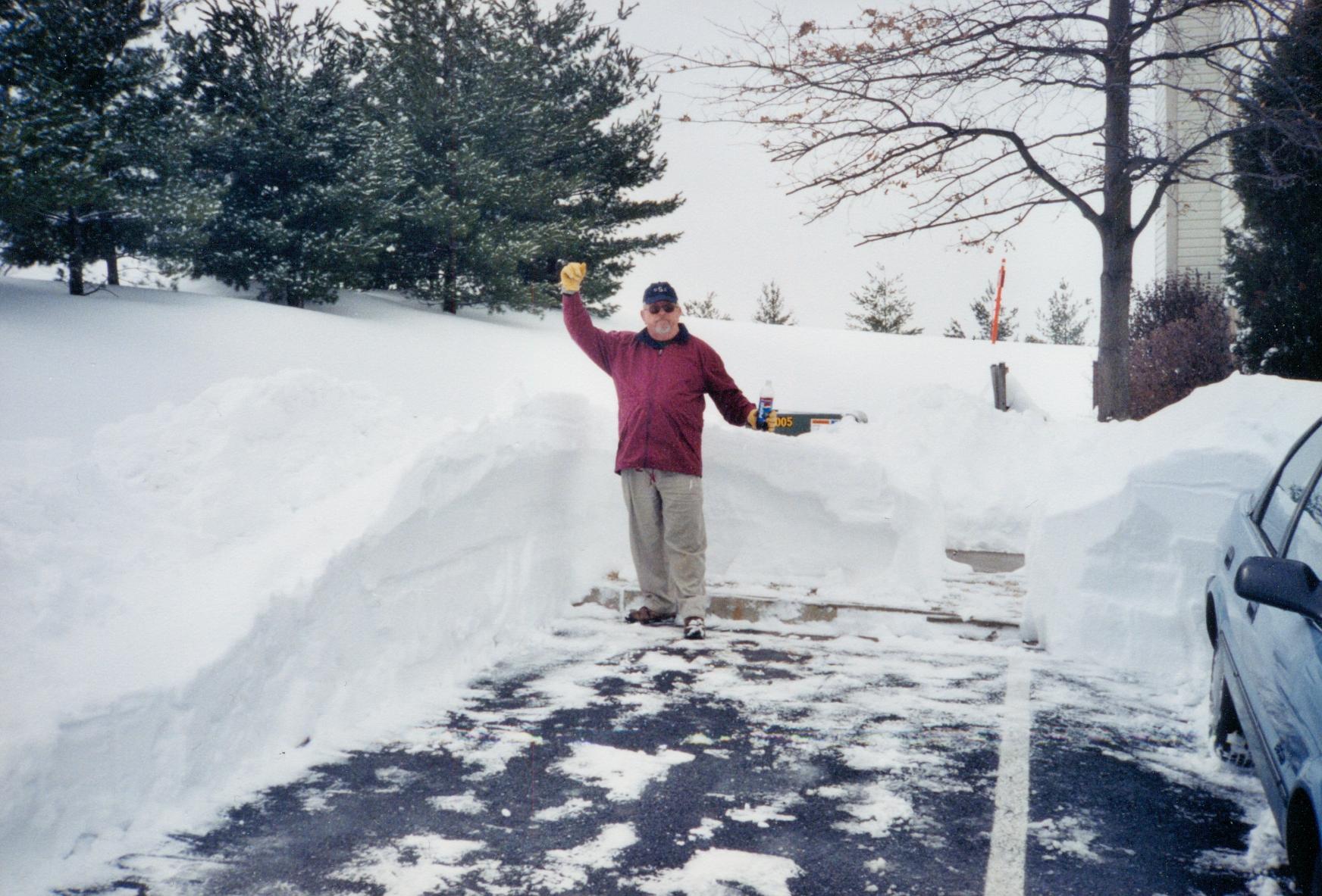 Dad shoveling snow at the tow…