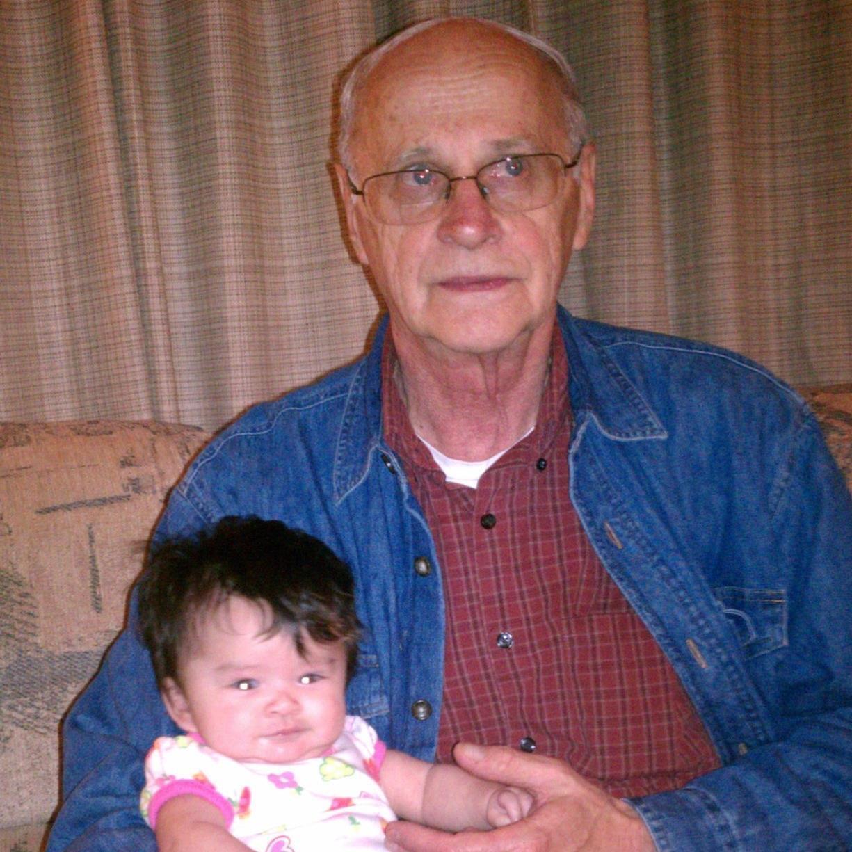 Grandpa Roger holds Chiana th…
